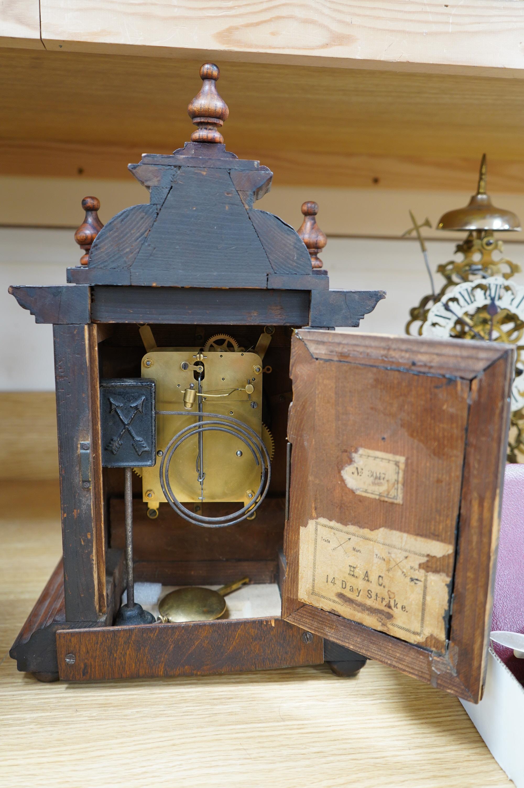 A late 19th century Black Forest walnut mantel clock with key and pendulum, 41cm. Condition - fair to good, not tested